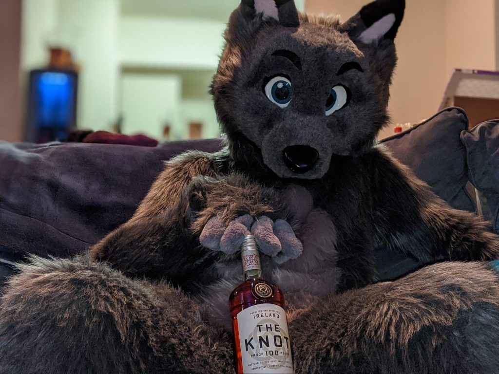 Seductive wolf eyes with a big bottle of "The Knot" ready for sipping